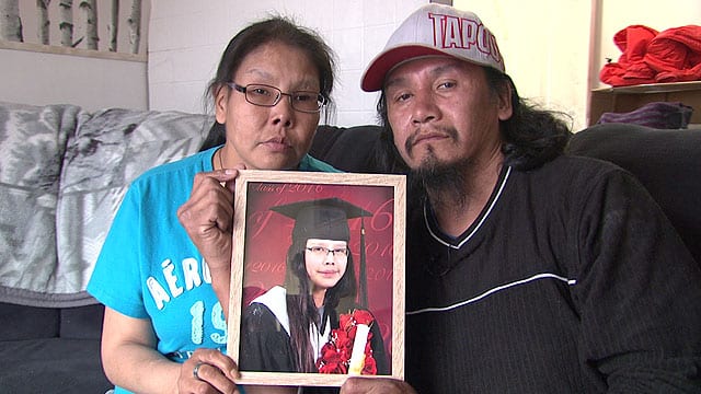 Barbara Suggashie, left, and her husband Clayton Suggashie hold the picture of their deceased daughter Kanina Sue Turtle who died by suicide Oct. 29, 2016. APTN file photo