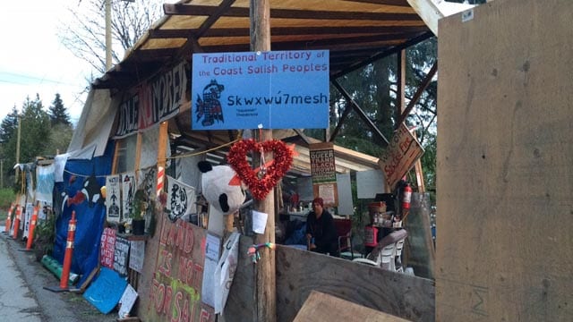 (Camp Cloud started as one trailer but now includes several tents, shelves for donated food, artwork and a small wooden shelter for women and children. Lucy Scholey/APTN)