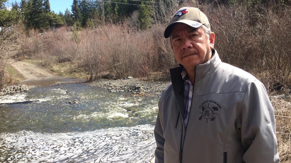 Coldwater Chief Lee Spahan stands by the Kwinshattin Creek, which runs over top the community's aquifer. He fears the proposed Trans Mountain pipeline expansion will endanger the First Nation's main source of drinking water