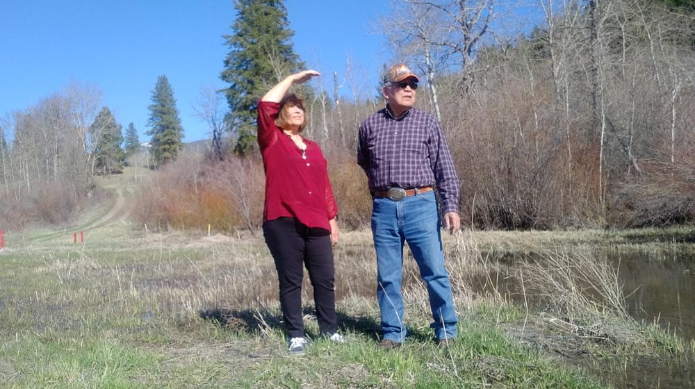 Janice Antoine and Percy Joe stand on their farmland in Coldwater, B.C. on April 23, 2018. The red markers indicate where the Trans Mountain pipeline sprung a leak in 2014. Lucy Scholey/APTN