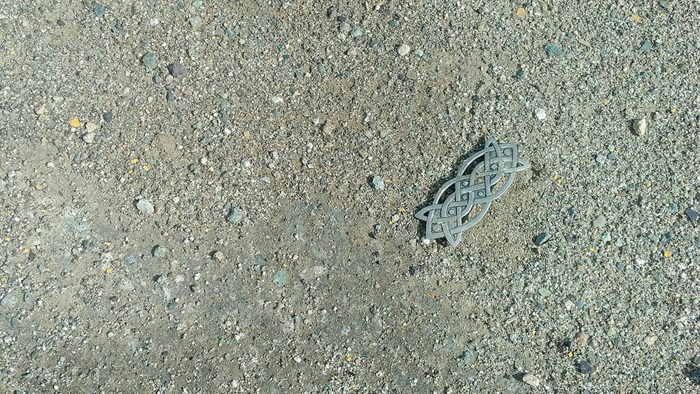 A woman's hair barrette is seen on the ground at Mine Creek Forest Road off Highway 5.